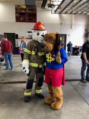 Dollar Dog with fire fighter mascot